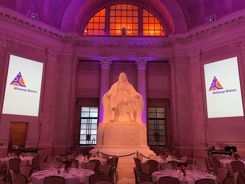 The Franklin Institute grand hall set for the customer event, statue lit in purple