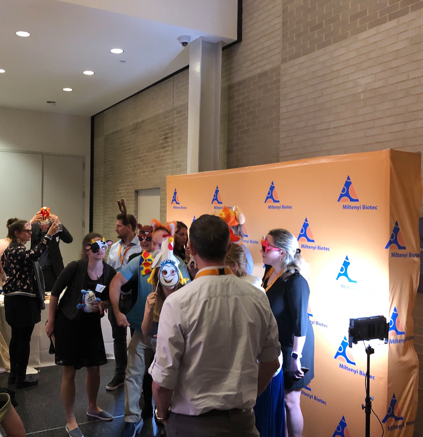 Guests posing at the branded photo booth with props