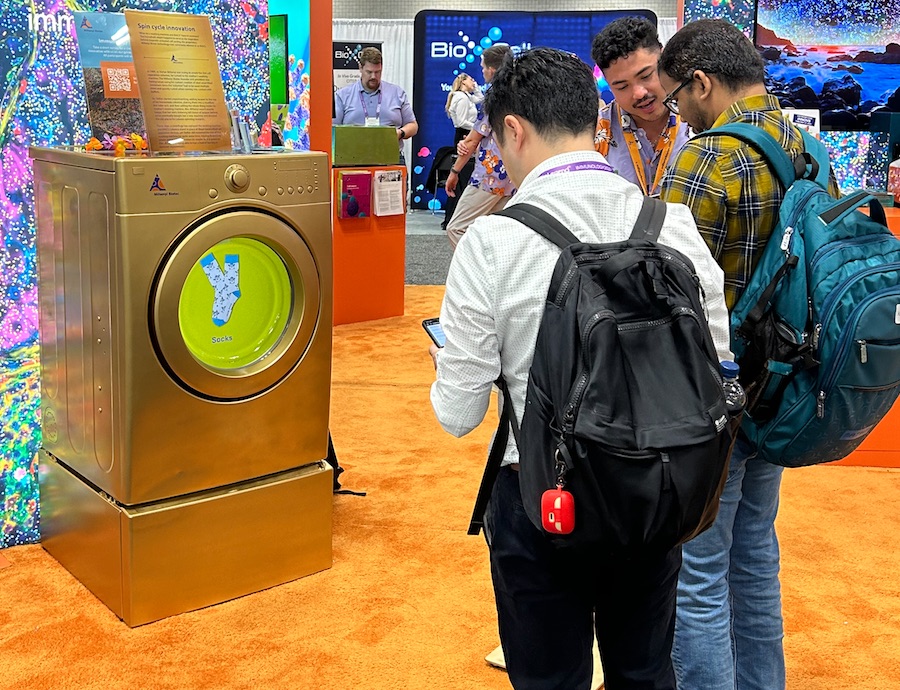 The Golden Washing Machine on the exhibit floor with attendees playing